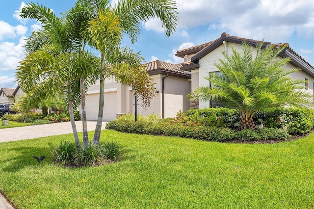 mediterranean / spanish home with a front lawn