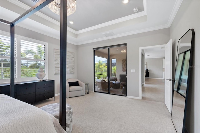 carpeted bedroom featuring a notable chandelier, crown molding, and a tray ceiling