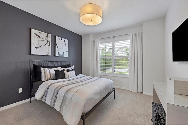 bedroom featuring light colored carpet