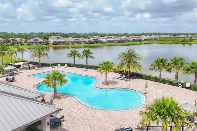 view of pool featuring a water view and a patio area