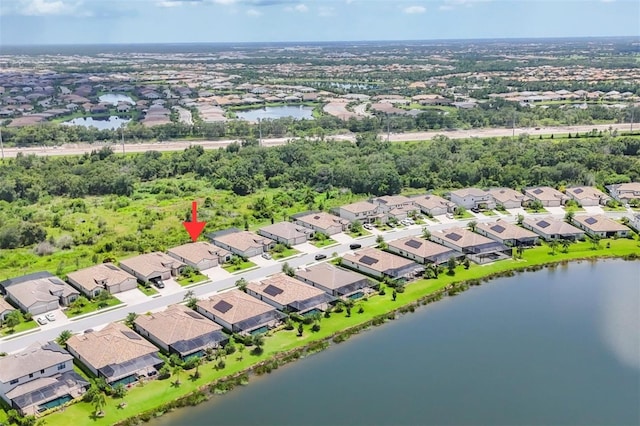 drone / aerial view featuring a water view and a residential view