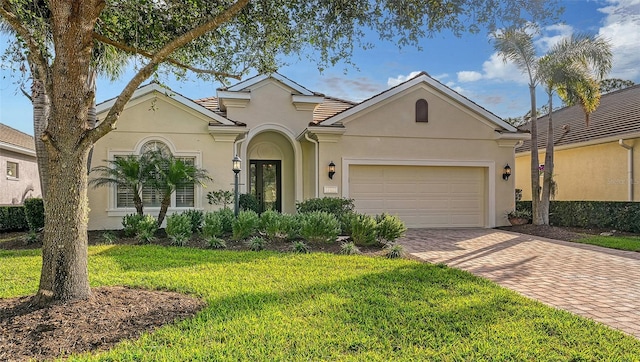 view of front of house with a garage and a front yard