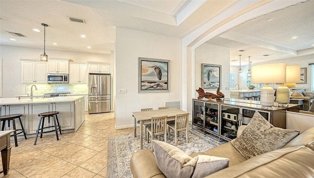 living room featuring light tile patterned flooring and sink