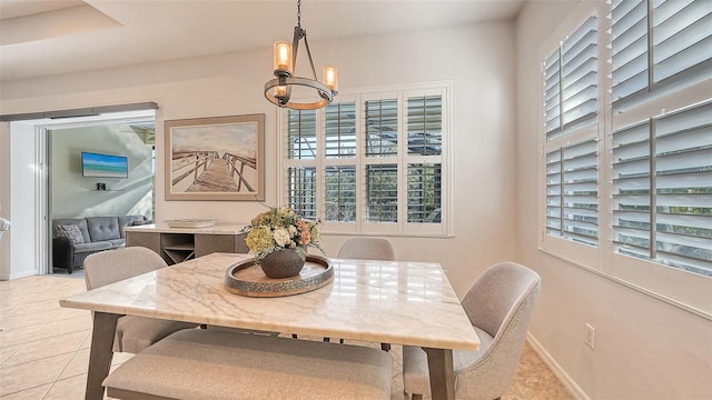 tiled dining space with a notable chandelier