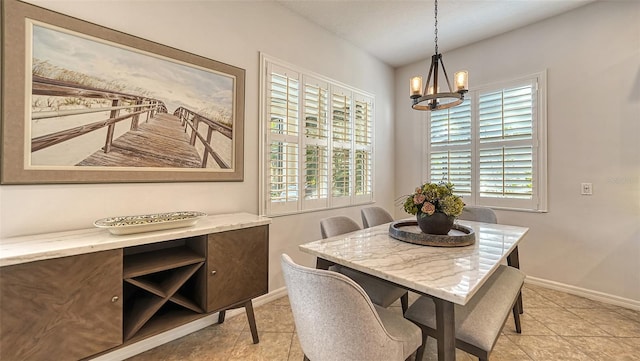 tiled dining area with an inviting chandelier