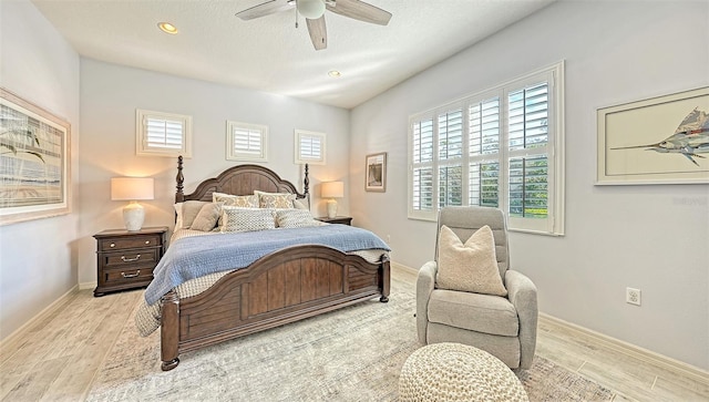 bedroom with light hardwood / wood-style flooring, multiple windows, and ceiling fan