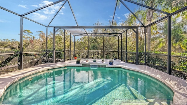 view of swimming pool featuring a patio and a lanai