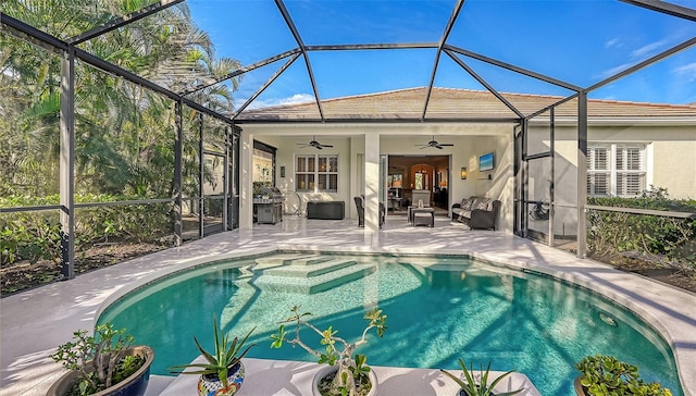 view of pool with a patio, a lanai, grilling area, and ceiling fan