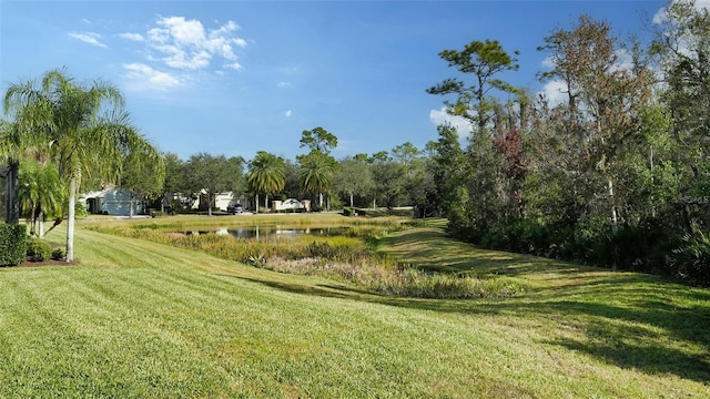 exterior space with a water view and a lawn