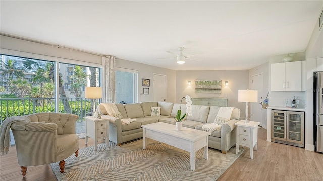 living room with light wood-type flooring, ceiling fan, and wine cooler