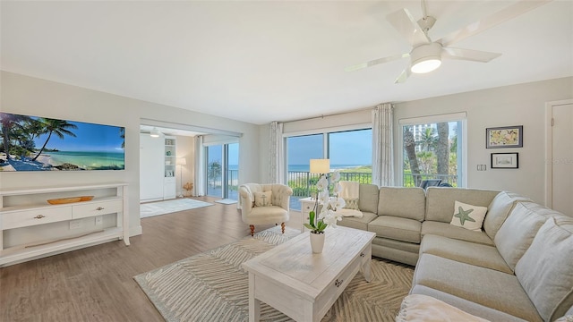 living room featuring light hardwood / wood-style flooring and ceiling fan