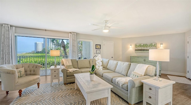 living room featuring hardwood / wood-style flooring and ceiling fan