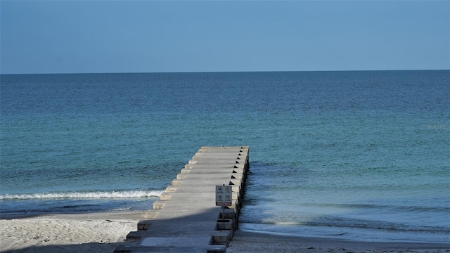 dock area with a water view and a view of the beach