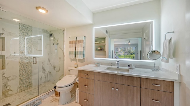 bathroom featuring vanity, a shower with door, tile patterned flooring, and toilet