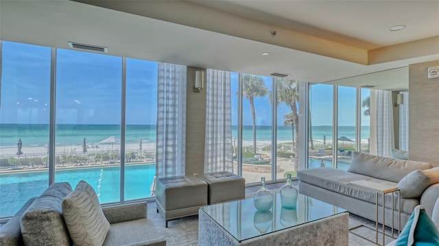 living room featuring a water view and a healthy amount of sunlight