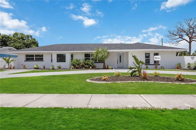 353 Suwanee Ave, Sarasota, FL 34243 - ranch-style home with a front lawn and stucco siding