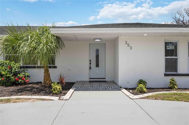 353 Suwanee Ave, Sarasota, FL 34243 - property entrance with stucco siding and roof with shingles