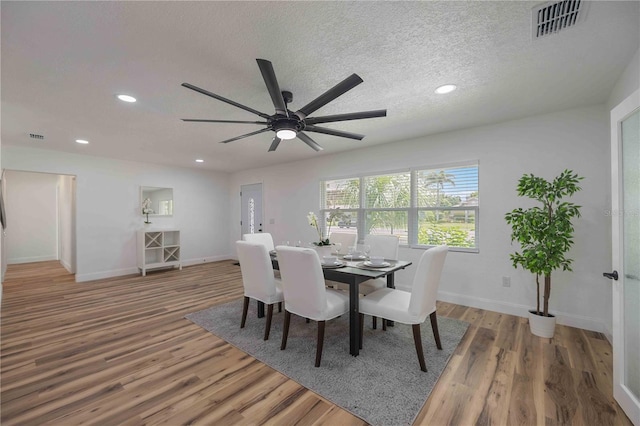 353 Suwanee Ave, Sarasota, FL 34243 - dining area with visible vents, a textured ceiling, wood finished floors, and recessed lighting