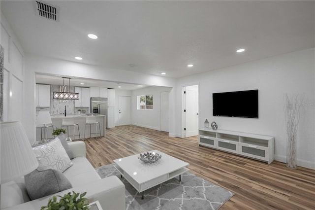 353 Suwanee Ave, Sarasota, FL 34243 - living area featuring baseboards, recessed lighting, visible vents, and light wood-style floors