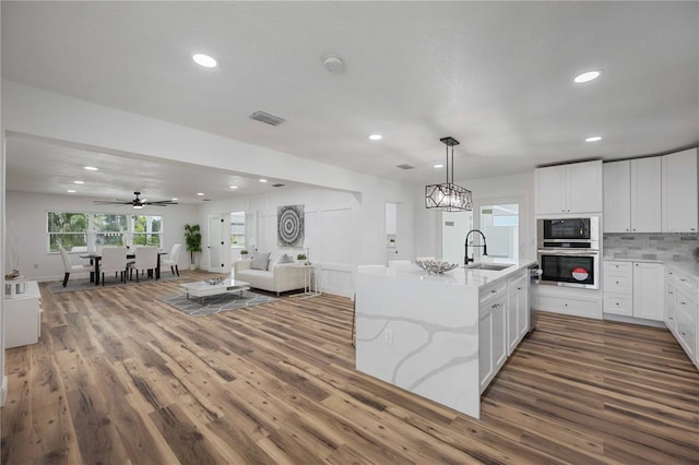 353 Suwanee Ave, Sarasota, FL 34243 - kitchen featuring a sink, open floor plan, built in microwave, visible vents, and oven