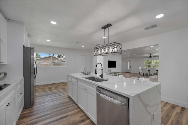 353 Suwanee Ave, Sarasota, FL 34243 - kitchen featuring visible vents, appliances with stainless steel finishes, white cabinetry, a sink, and open floor plan