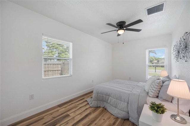 bedroom featuring wood-type flooring and ceiling fan