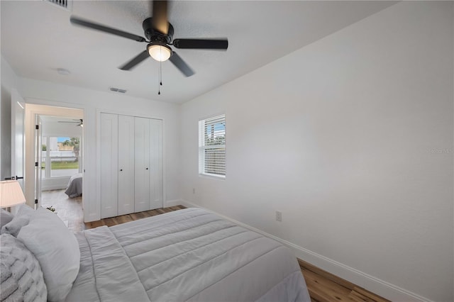 353 Suwanee Ave, Sarasota, FL 34243 - bedroom featuring a closet, visible vents, baseboards, ceiling fan, and wood finished floors