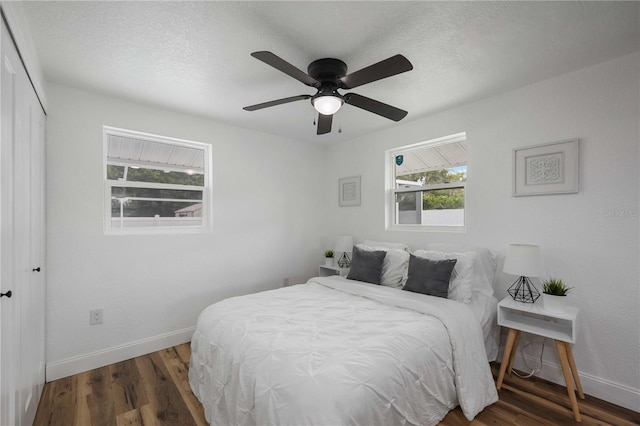 353 Suwanee Ave, Sarasota, FL 34243 - bedroom with baseboards, a textured ceiling, wood finished floors, and a closet