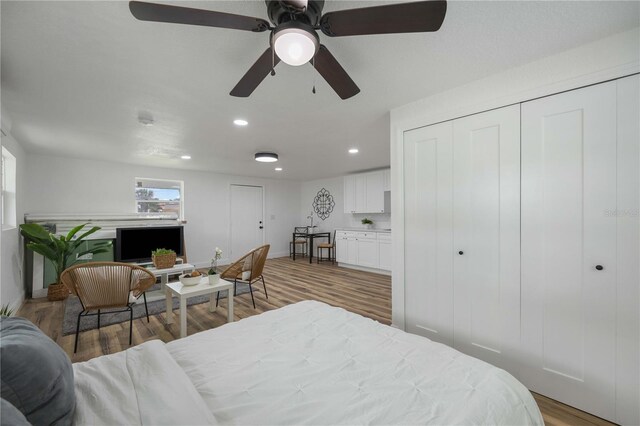 bedroom with light wood-type flooring and ceiling fan