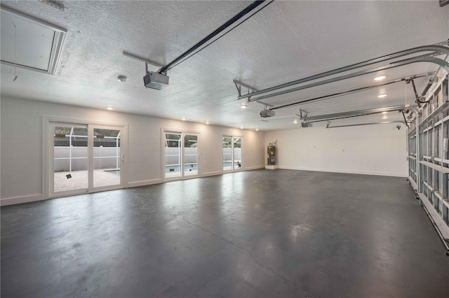 garage featuring electric water heater and a garage door opener