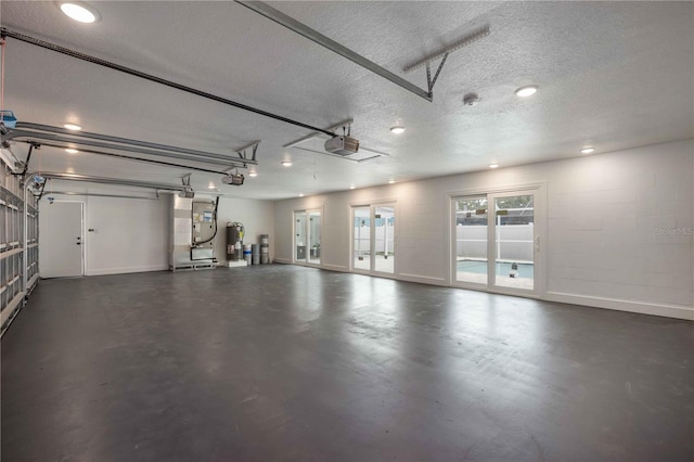 353 Suwanee Ave, Sarasota, FL 34243 - garage featuring electric water heater, baseboards, and a garage door opener