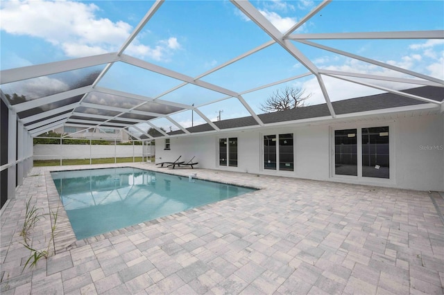 view of pool featuring a patio and glass enclosure