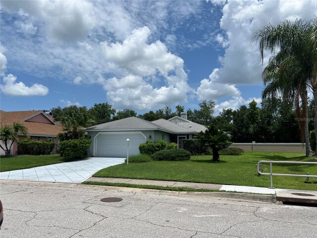 view of front of house featuring a garage and a front lawn