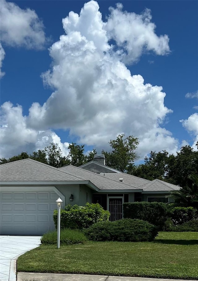 view of front of property with a garage and a front yard