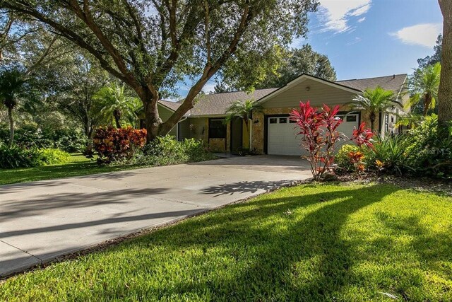 ranch-style house with a garage and a front yard