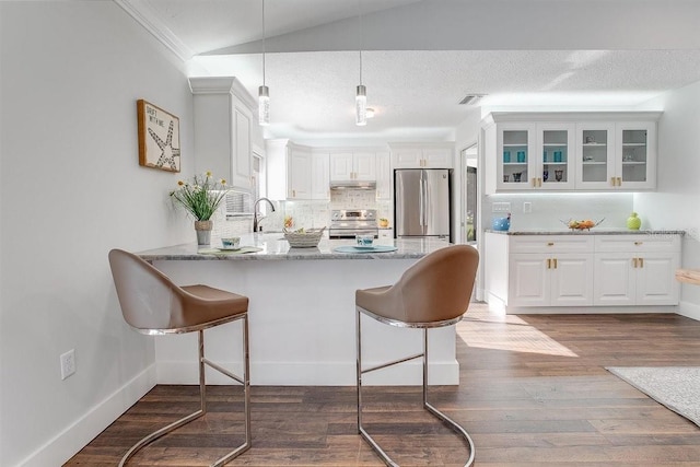 kitchen featuring light stone countertops, appliances with stainless steel finishes, sink, and white cabinets