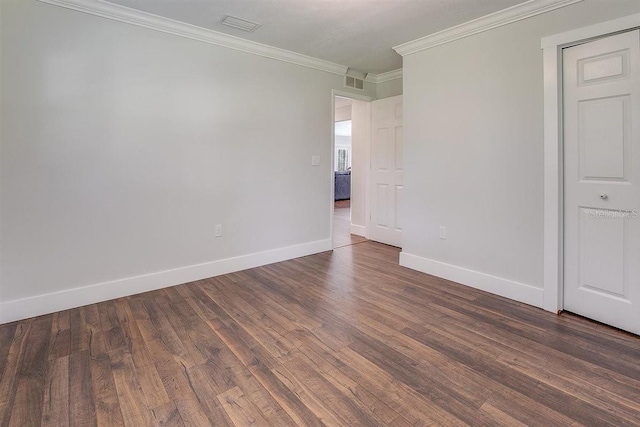 unfurnished room featuring crown molding and dark wood-type flooring