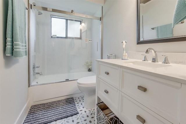 full bathroom with tile patterned floors, vanity, toilet, and combined bath / shower with glass door