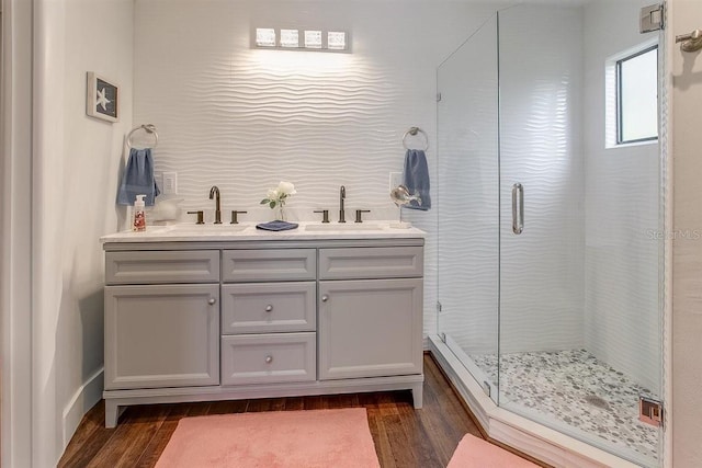 bathroom featuring a shower with door, vanity, and hardwood / wood-style floors