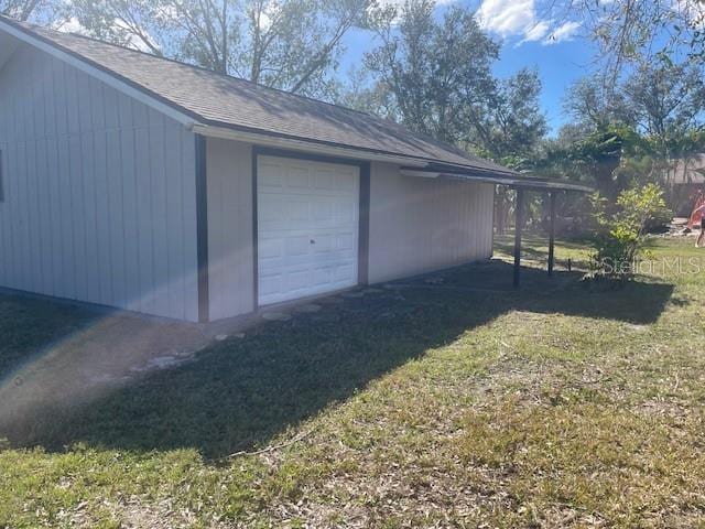 garage featuring a lawn