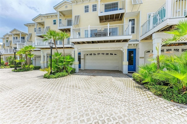 view of front facade with a balcony and a garage