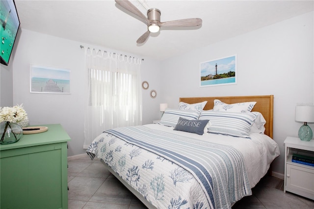 tiled bedroom featuring ceiling fan