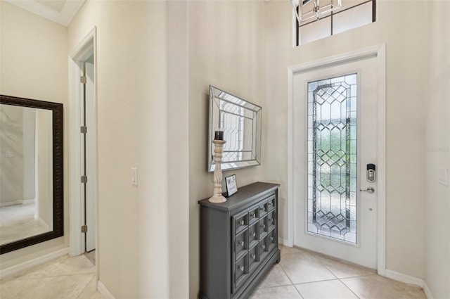 foyer entrance with light tile patterned flooring and a healthy amount of sunlight