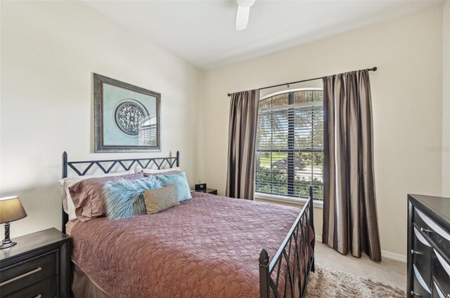 bedroom featuring ceiling fan and light colored carpet