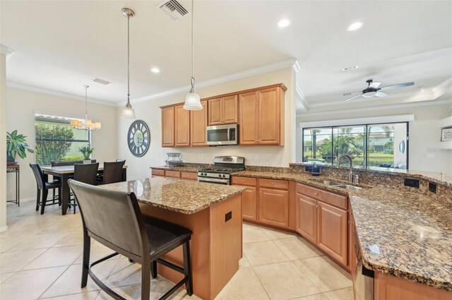 kitchen featuring sink, ceiling fan with notable chandelier, stainless steel appliances, and light tile patterned floors