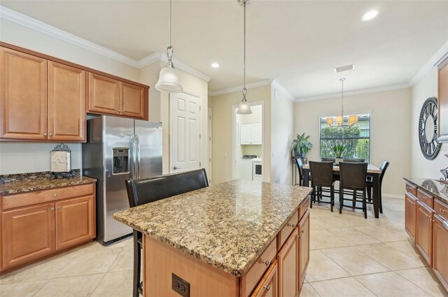 kitchen with a kitchen island, crown molding, stone countertops, stainless steel fridge with ice dispenser, and light tile patterned flooring