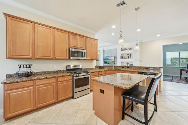 kitchen with stainless steel appliances, a breakfast bar, pendant lighting, kitchen peninsula, and light tile patterned floors