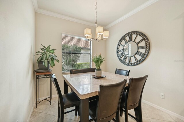 dining area featuring ornamental molding, a notable chandelier, and light tile patterned floors