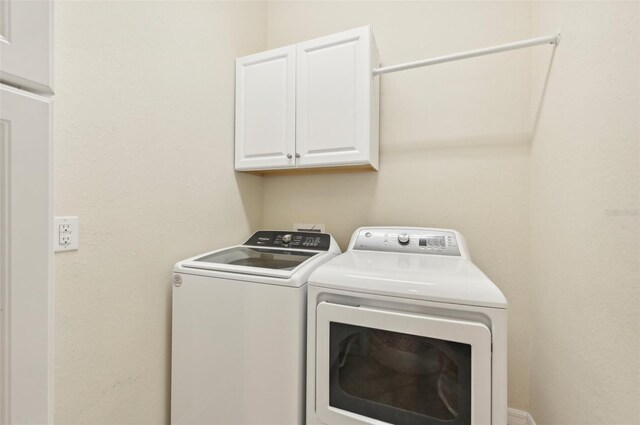 laundry area featuring cabinets and independent washer and dryer