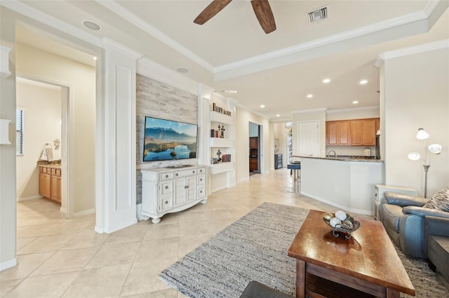 living room with built in features, crown molding, ceiling fan, and light tile patterned floors